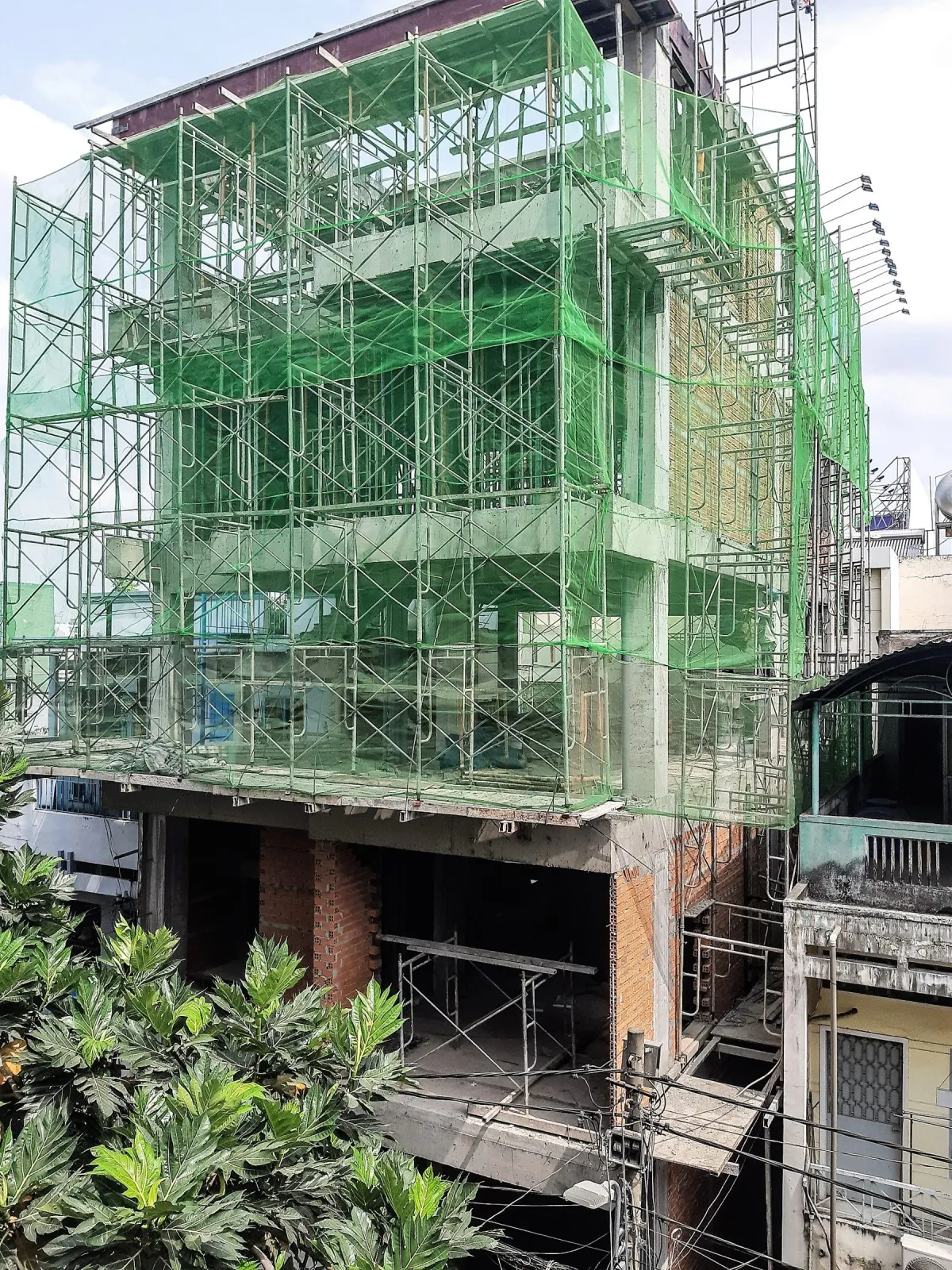 Công trình đang thi công với lưới an toàn xanh