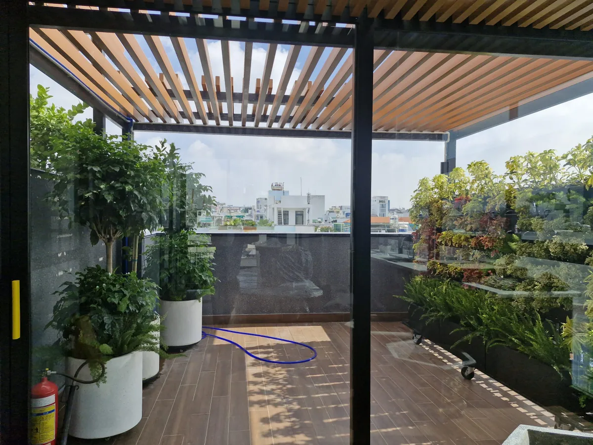 Sân thượng pergola gỗ và vườn cây MXT House